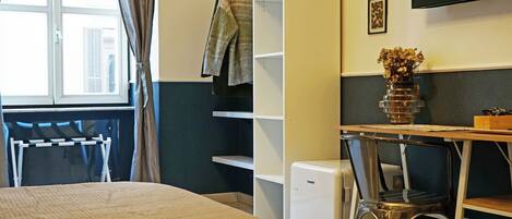 Un dormitorio con cama, escritorio, silla, televisor y ventana con cortinas.