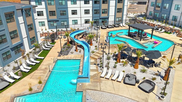A resort with multiple swimming pools, a lazy river, and outdoor seating areas. - The Way Station: Resort Pools, Lazy River, Waterslide + Pickleball (Hurricane)