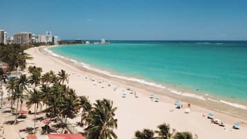 On the beach, white sand, beach umbrellas, beach towels