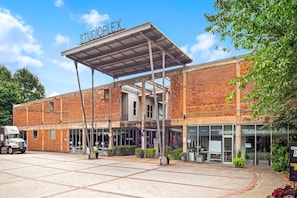 A building with a sign reading "STUDIOPLEX" and a covered entrance.