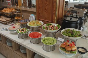 A buffet with various food items and a coffee station. - Hanoi Sail Hotel (Hanoi)