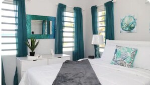 A bedroom with a bed, a desk, a chair, a lamp, and a plant. - Modern Home in the Countryside (Pares)