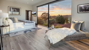 A modern bedroom with a large sliding glass door leading to a scenic outdoor view. - Gayle Villa - Stunning Modern Masterpiece with Breathtaking Views (Los Angeles)