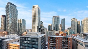 A cityscape with modern high-rise buildings, some with glass facades and others with brick exteriors. - GLOBALSTAY Modern 1BD+Den Condo w/ Balcony Lillian St (Toronto/Canada)