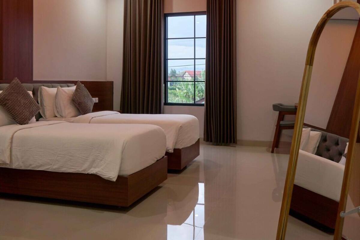 Un dormitorio moderno con una cama grande, una mesita y un espejo.