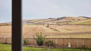 A rural landscape with rolling hills and a fenced field. - Host & Stay | Audrey's Cottage (Kirk Yetholm)