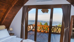 A bedroom with a large window, wooden ceiling, and a view of a balcony with a railing. - Exclusive Hill Sapanca (Sapanca)