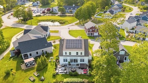 A residential area with houses, a driveway, and a solar panel on one house. - Golf-front Personal Arcade Hot tub Outdoor Kitchen (Old Orchard Beach)
