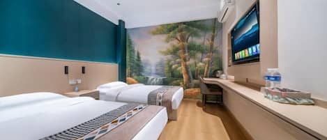 A hotel room with two beds, a desk, a TV, and a painting of a forest scene.