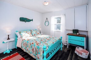 A bedroom with a bed, a dresser, a window, and a wall-mounted fish decoration. - 5 Minutes to the beach. 3 Bedroom, water view Bungalow. Close to Cavendish (York)