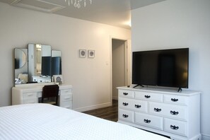 A bedroom with a bed, a dresser, a television, and a mirror. - Waterview, 3 BR, Close to Cavendish and Beach (York)