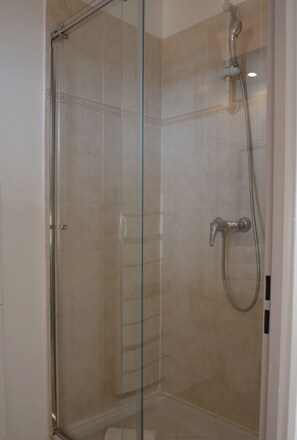 Shower, hair dryer, towels, toilet paper