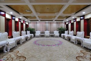 A conference room with a long table and rows of chairs, a patterned carpet, and a decorative ceiling. - Inner Mongolia Uiles Hotel (Hohhot)