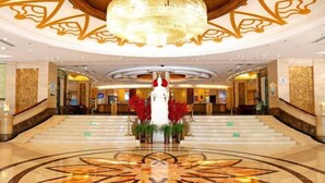 A grand lobby with a marble floor, a large chandelier, and a central statue. - Inner Mongolia Uiles Hotel (Hohhot)