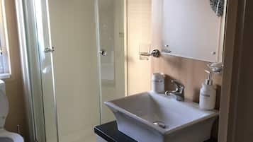 Shower, hair dryer, towels, toilet paper