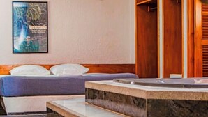 A hotel room with a bed, a poster on the wall, wooden closets, and a marble-tiled floor. - HOTEL ESPOR CA (Barinas)