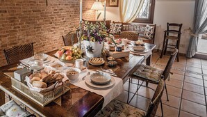 A dining table set with various dishes, a vase of flowers, and a candle.