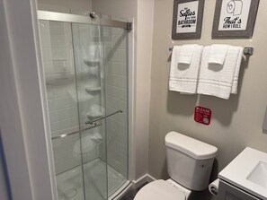 Shower, hair dryer, towels, toilet paper