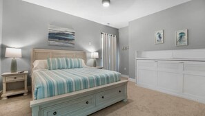 A bedroom with a bed, nightstands, a dresser, and artwork on the walls. - Hidden Valley Paradise (Glaze Township)