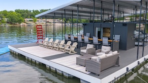 A floating deck with outdoor seating, a covered area, and a view of the water. - Hidden Valley Paradise (Glaze Township)