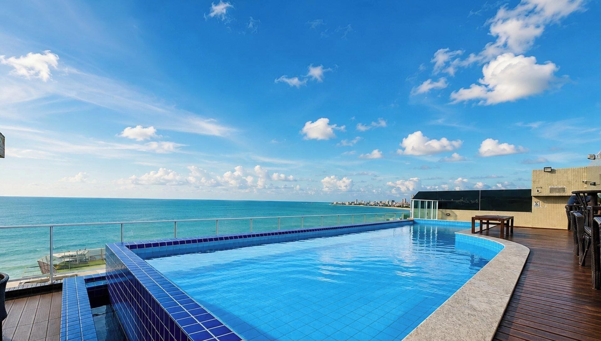 Ein Pool mit Blick auf den Ozean und eine entfernte Skyline.
