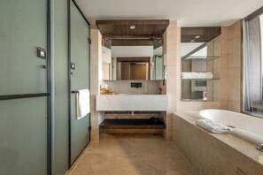 A modern bathroom with a large mirror, a white sink, a bathtub, and a glass shower enclosure. - Rishengchang Hotel (Beijing South Railway Station) (Beijing)