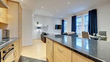Comfort Apartment | Private kitchen | Full-sized fridge, microwave, dining tables