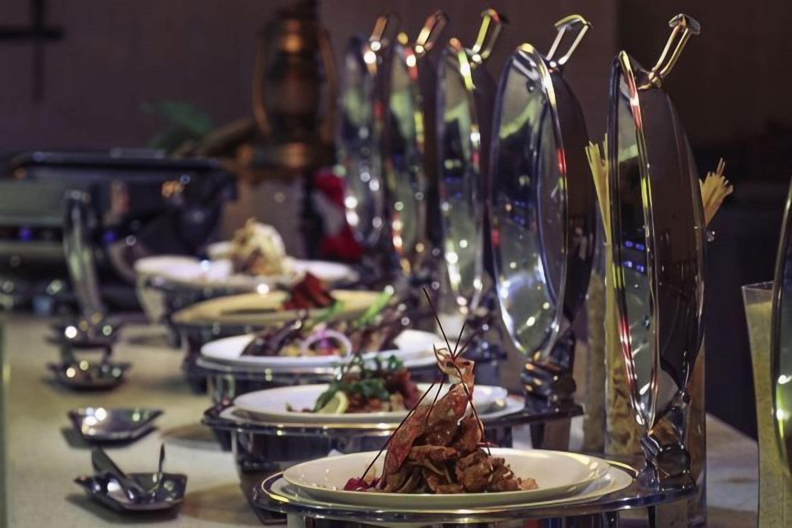 A table set with plates of food, glasses, and cutlery.