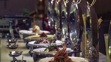 A table set with plates of food, glasses, and cutlery.