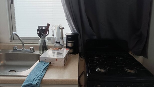 A kitchen with a sink, stove, and various kitchen utensils. - Small Independent Studio in Zapopan (Zapopan)
