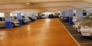 A multi-level underground parking garage with cars parked in rows.