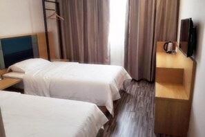 A hotel room with two single beds, a wooden nightstand, a television, and a coffee maker. - Ripple Hotel (Shanghai Xinqiao Town) (Shanghai)