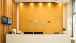 A reception desk with a wooden panel wall, a digital screen, and a logo. - Ripple Hotel (Shanghai Xinqiao Town) (Shanghai)