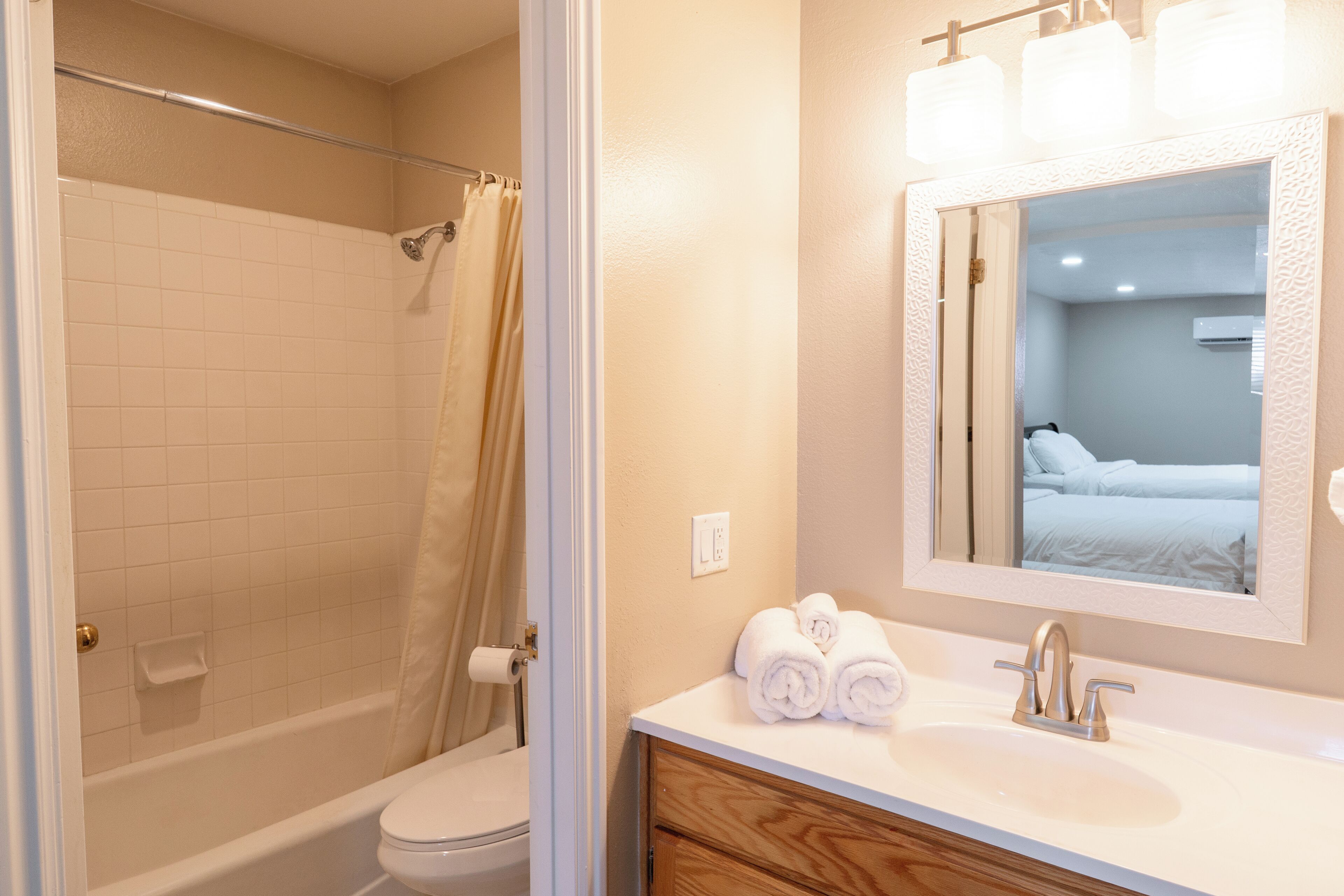 A bathroom with a bathtub, toilet, and sink.