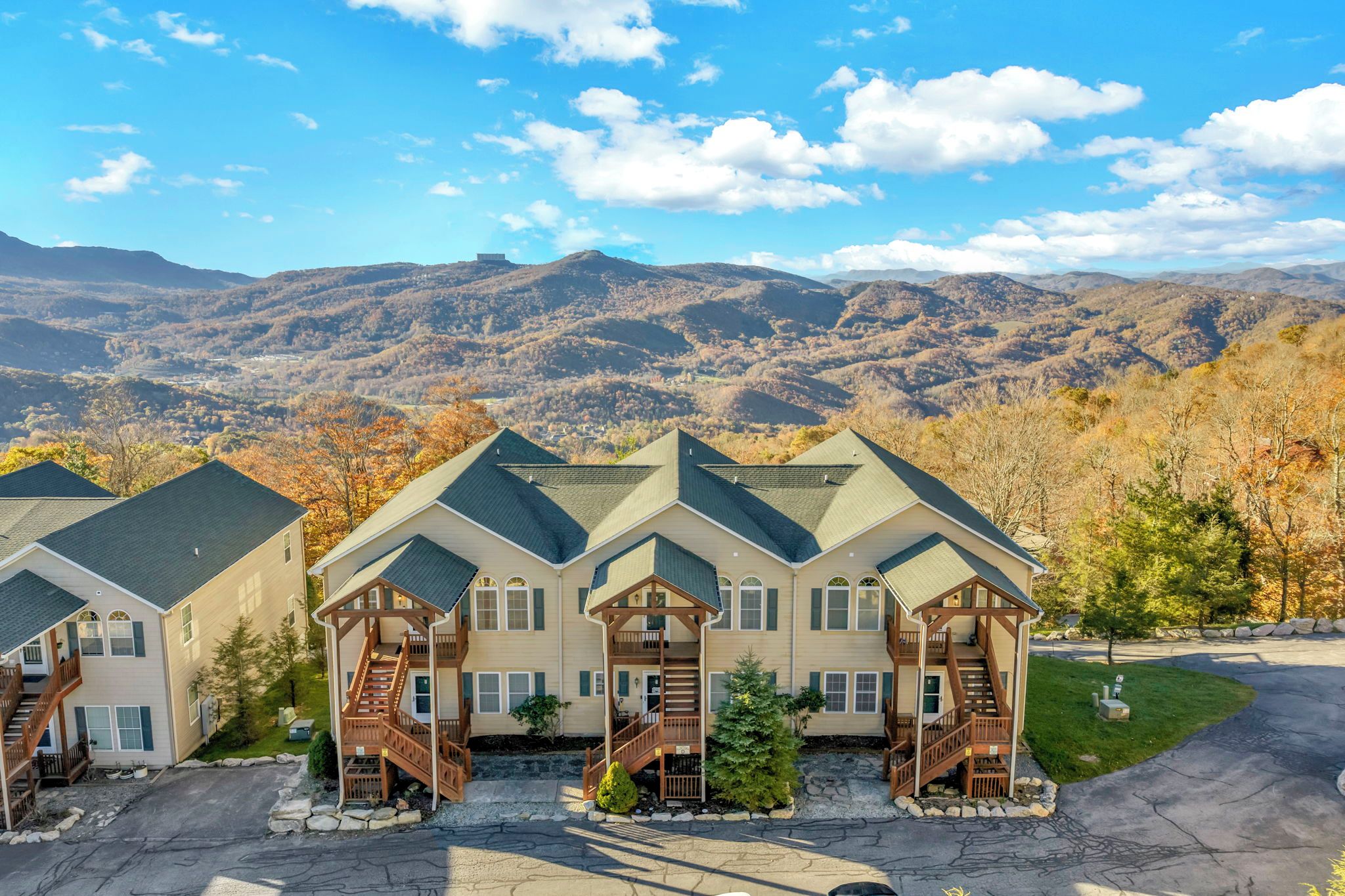 A multi-story building with a central staircase and a view of a mountainous landscape.