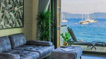 Departamento Deluxe, vista al mar, frente al mar | Área de sala de estar | Televisión