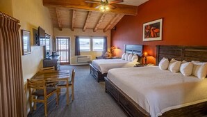 A hotel room with two beds, a desk, a chair, and a ceiling fan. - Boulder Mountain Lodge (Boulder)