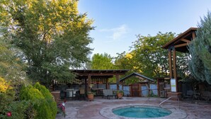 A backyard with a swimming pool, patio furniture, and a covered seating area. - Boulder Mountain Lodge (Boulder)