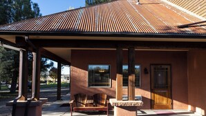 A building with a covered porch, a wooden bench, and a door. - Boulder Mountain Lodge (Boulder)