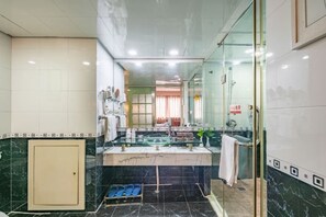 A modern bathroom with a glass shower enclosure, a vanity with a glass basin, and a marble-tiled floor. - Jinye Hotel (zhanggongqiao Food Street) (Leshan)