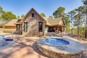 A stone house with a swimming pool and patio. - Fire Pit + Patio: Spacious Southern Pines Retreat (Southern Pines)
