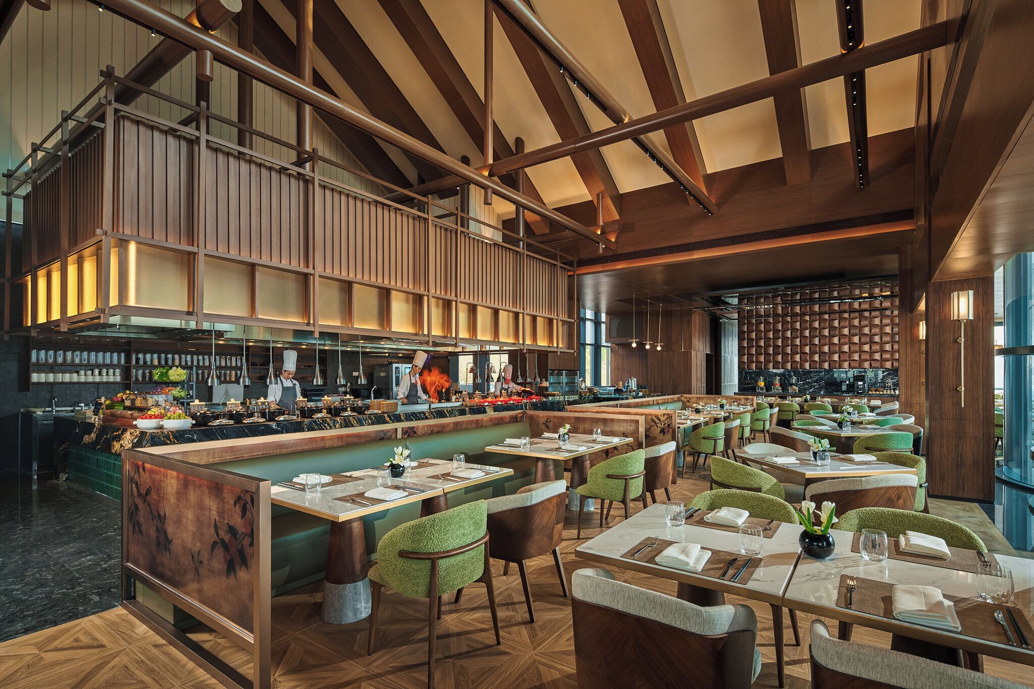 A spacious restaurant with high ceilings, exposed beams, and a central bar area.
