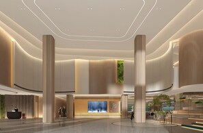 A spacious lobby with high ceilings, a reception desk, and a coffee shop area. - EVEN Hotel Wuhan Airport Zone by IHG (Wuhan)