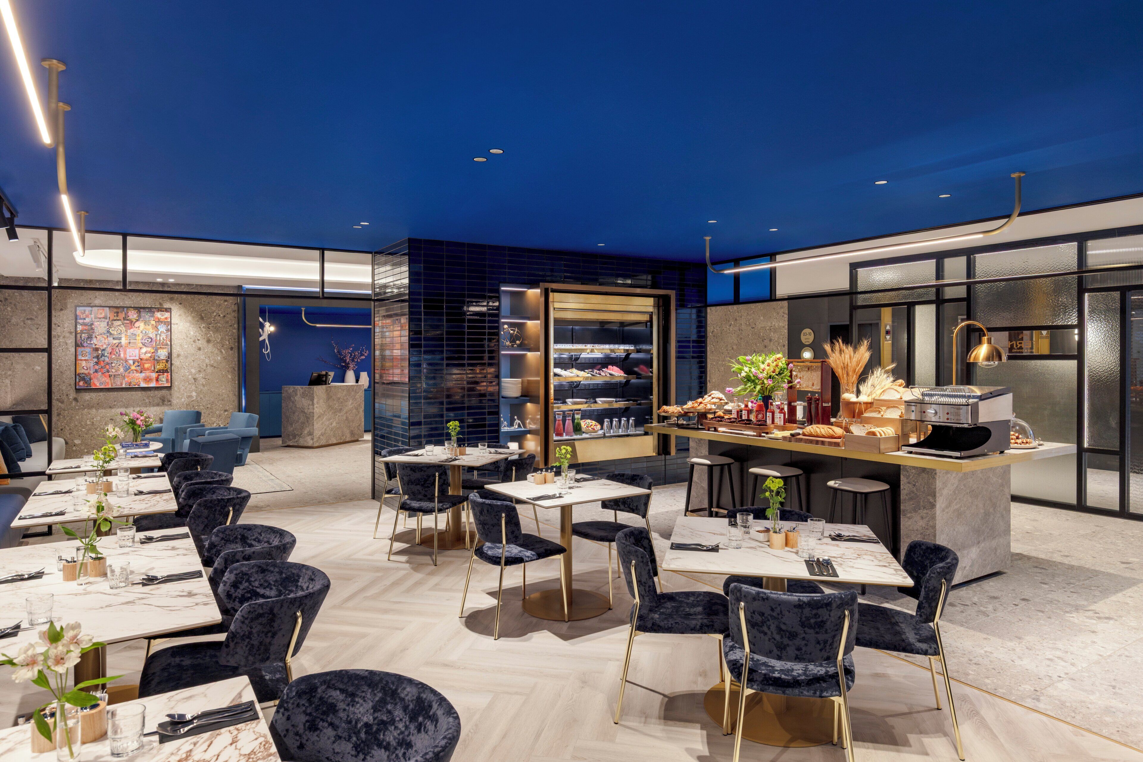 A modern restaurant with a bar area, seating for 20 guests, and a kitchen visible through a glass partition.