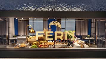 A restaurant with a modern interior, a visible menu board, and a variety of food items displayed.