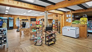 A rustic-themed store with wooden beams, a chalkboard menu, and various snack displays. - River & Ranch Retreat: Fish, Raft, Hike & Ride in Rocky Mountain Bliss (Almont)