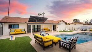 A backyard with a swimming pool, outdoor furniture, and a solar panel. - Sexy Boutique Estate in Fun Size - Swank Chill Vibe - Mill Ave - Spring Training (Tempe)