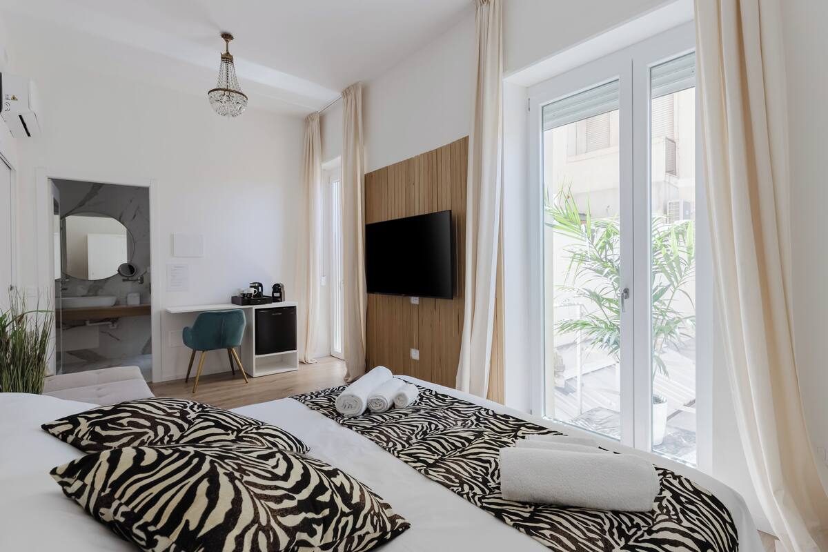 Family Room, Courtyard View | 1 bedroom, in-room safe, desk, laptop workspace