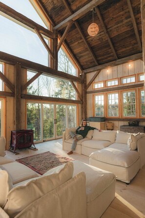 A spacious living room with large windows, a wooden ceiling, and a cozy seating area. - Gorgeous couples barn with WiFi & hot tub in lovely Londonderry (Londonderry)
