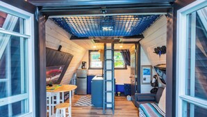 A compact, modern interior with a kitchen, dining area, and seating space. - A FRAME ALPHA -WoW This Old Tree
 (Five Islands)
